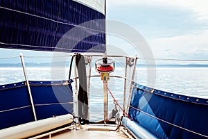 Foresail and tip of a sailbaot on a tranquil day on the water