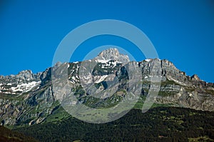 Forest, alpine landscape and blue sky in Saint-Gervais-Les-Bains photo