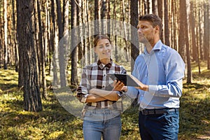 forest appraiser or buyer and owner doing property inspection and valuation photo