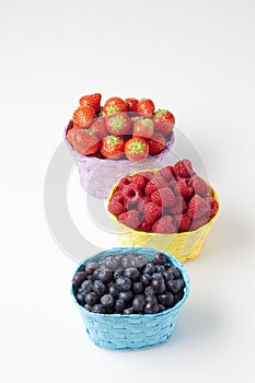 Forest berries, raspberries, blueberries and strawberries in baskets