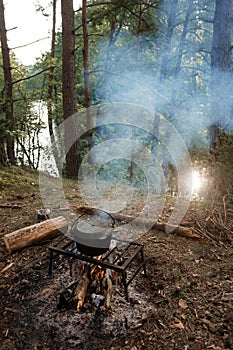 Forest cooking on campfire in the morning.
