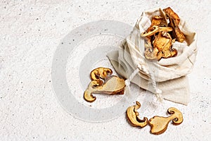 Forest dried edible mushrooms in a linen sack