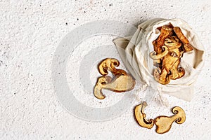 Forest dried edible mushrooms in a linen sack