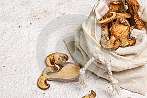 Forest dried edible mushrooms in a linen sack