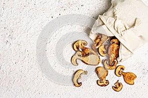 Forest dried edible mushrooms in a linen sack