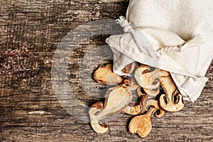 Forest dried edible mushrooms in a linen sack