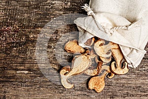 Forest dried edible mushrooms in a linen sack