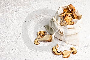 Forest dried edible mushrooms in a linen sack