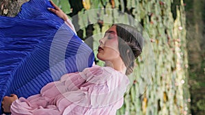 Forest fairy sitting lake water lilies close up. Dreamy woman posing vertically