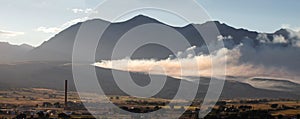 Forest fire control burn with smoke drifting at sunset in Salida Colorado USA