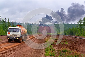 Forest fire. Illegal burn refuse, poisonous smoke, fire and fumes, clouds of toxic smoke. Smoke over forest and power plant. Air