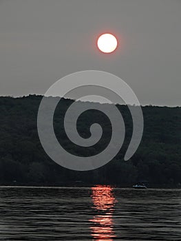 Forest fire smoke creates orange sunset on Cayuga Lake