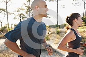 Forest, fitness and coach running with woman as a workout or morning exercise for health and wellness together. Sport