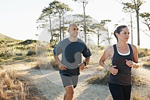 Forest, fitness and running couple training, workout and doing morning exercise for health and wellness together. Sport