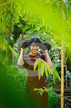 Forest garden in Indian woman purple dress relax style concept. 20s Asian female black short hair