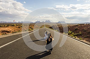 Forest Gump Point, tourist girls taking pictures - Monument Valley scenic panorama on the road - Arizona, AZ