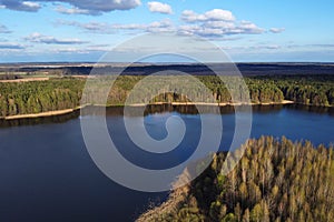 Forest lake, aerial shot of storage reservoir. Spring landscape with blue sky and white clouds at sunny day, river, European
