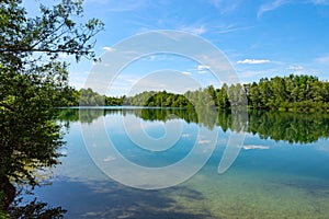 Forest lake in German national park with clear blue sky reflection