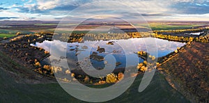 Forest Lake at sunset. Wild Lake in swamp, drone view. Rural landscape with lakes. Forest at bog