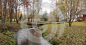 Forest lodge in backwoods, wild area in beautiful forest in Autumn, Valday national park, yellow leafs at the ground