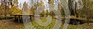 Forest lodge in backwoods, Wooden arbor, wild area in beautiful forest in Autumn, Specular reflection in water, Valday