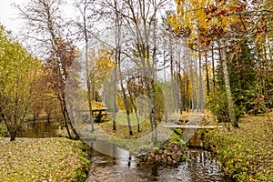 Forest lodge in backwoods, Wooden arbor, wild area in beautiful forest in Autumn, Specular reflection in water, Valday