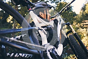 Forest, man carry and mountain bike in nature of a cyclist ready for training, exercise and bicycle workout outdoor