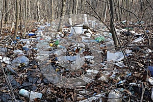 Forest pollution with old cans, watrer bottles, plastic containers