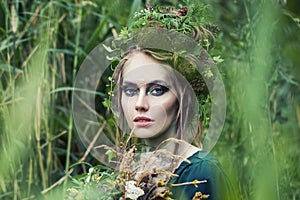 Forest portrait of fairy nymph woman in green grass outdoors