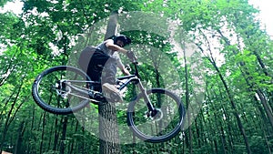 Forest ramps and a bike rider doing dirt jumping over them