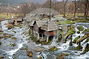 Forest river and wooden water mills