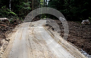 Forest road for construction and mining purposes in the forest dug boulders
