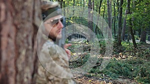 Forest setting, laser precision, camouflage shooter