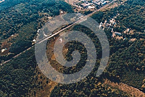 Forest and village in Ukraine, flight over the village of Klevan, view of the love tunnel from above