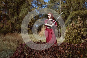 In the forest, a woman with a sword. photo