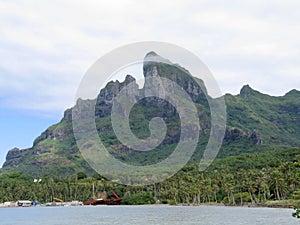 Forested mountain under a cloudy sky in bora bora. french Polynesia