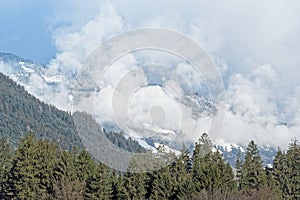 Forested mountains in dense clouds in a winter. Ziller Valle in, Austria