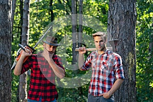 Foresters men. Man with serious face carries axe. Lumberjack brutal holds axe. Brutal lumberjack concept.