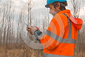 Forestry technician flying a drone with remote controller