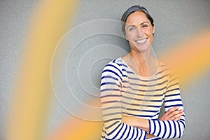 Forever beautiful. Portrait of an attractive mature woman in casualwear standing against a gray wall.