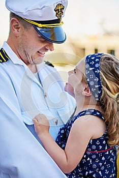 Forever daddys little girl. a father in a navy uniform bonding with his little girl on the dock.