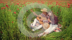 Forever love. couple with guitar. man and woman in poppy flower field. summer vacation. happy family. country music