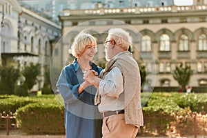 Forever together. Happy senior couple dancing and smiling while standing outdoors