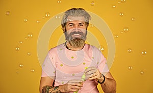 Forever young guy. Positive. Carefree man soap bubbles. Summer vacation. Infantility concept. Happy playful bearded