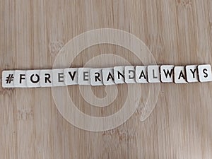 #foreverandalways forever and always written on wood blocks on a wood background