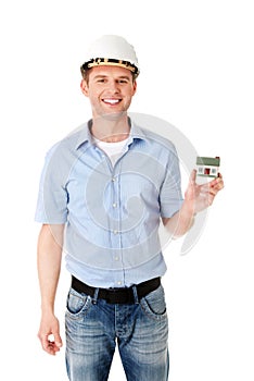 A forewoman holding a model house