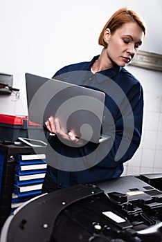 forewoman with laptop making diagnostics of