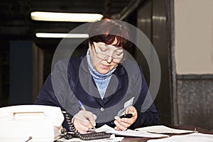 Forewoman writing at the desk