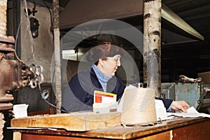 Forewoman writing at workplace