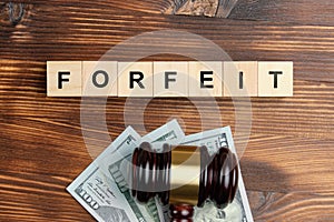 Forfeit concept as an inscription on a sticker next to the judge hammer photo